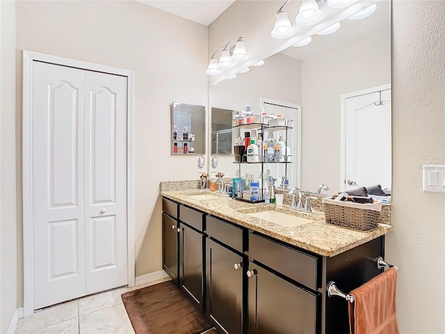 bathroom featuring double sink vanity and tile floors