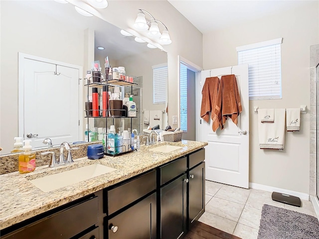 bathroom featuring walk in shower, tile flooring, vanity with extensive cabinet space, and dual sinks