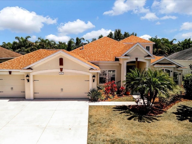 mediterranean / spanish house with a garage