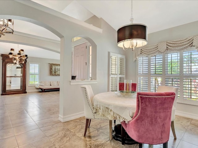 tiled dining area featuring vaulted ceiling and an inviting chandelier