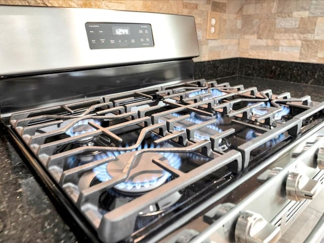 room details featuring backsplash and stainless steel gas stove