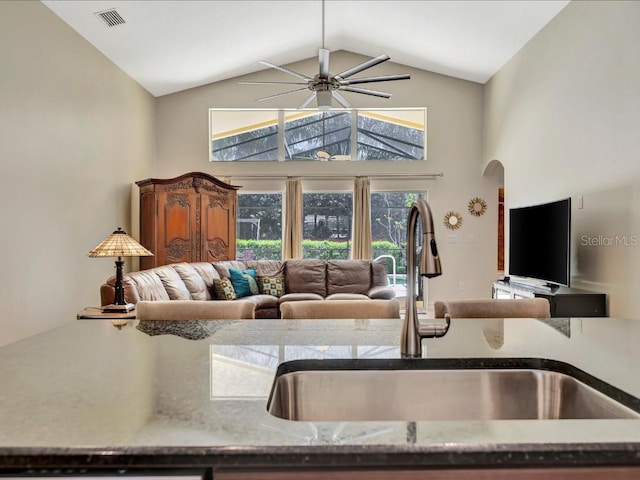 living room with high vaulted ceiling, sink, and ceiling fan