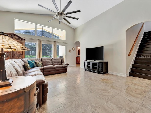 tiled living room featuring high vaulted ceiling and ceiling fan