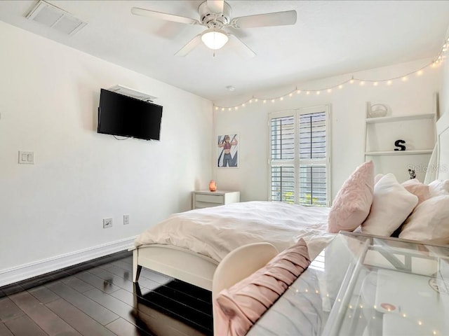 bedroom with ceiling fan and dark wood-type flooring