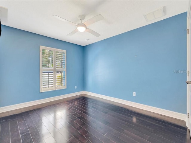 empty room with ceiling fan and dark wood-type flooring