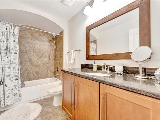 full bathroom featuring toilet, shower / bath combo with shower curtain, a textured ceiling, vanity, and tile floors