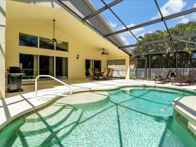 view of pool featuring a patio, ceiling fan, grilling area, and glass enclosure