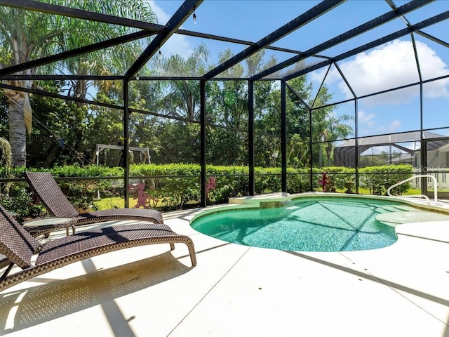 view of swimming pool with a patio and glass enclosure