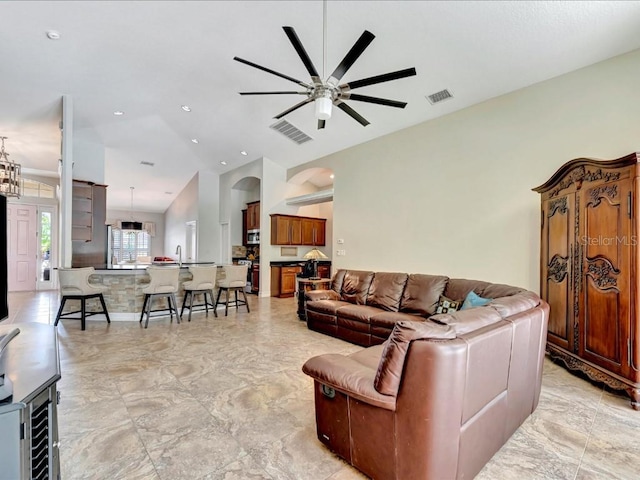 living room with sink, ceiling fan, and light tile floors