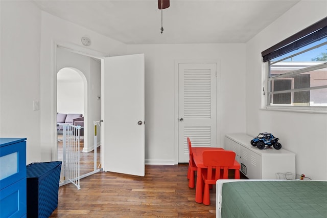 bedroom featuring a closet, ceiling fan, and dark hardwood / wood-style floors