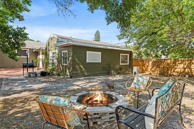 back of house featuring a fire pit and a patio area