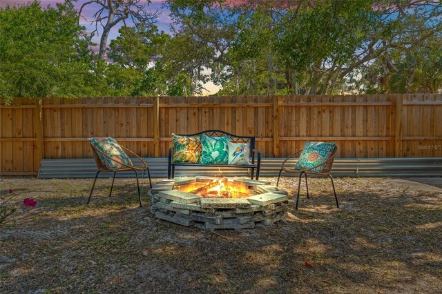 yard at dusk with an outdoor fire pit