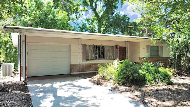 single story home with a garage and central AC