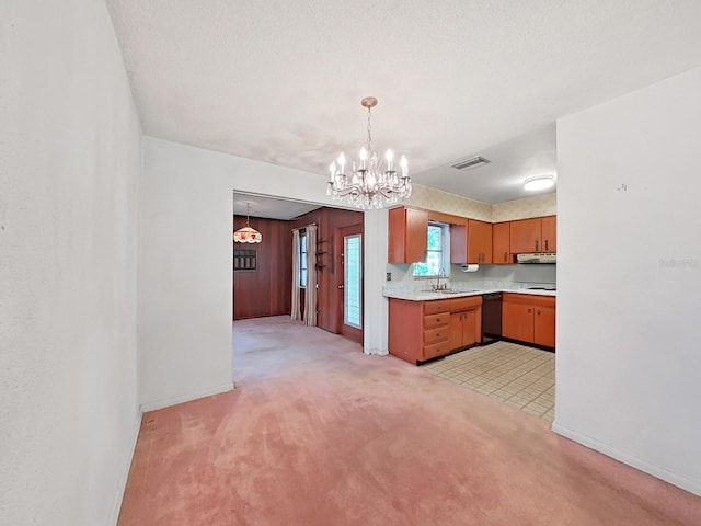 kitchen featuring light carpet, sink, dishwasher, decorative light fixtures, and an inviting chandelier