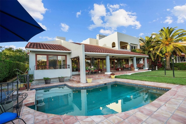 exterior space with ceiling fan, a yard, and a patio