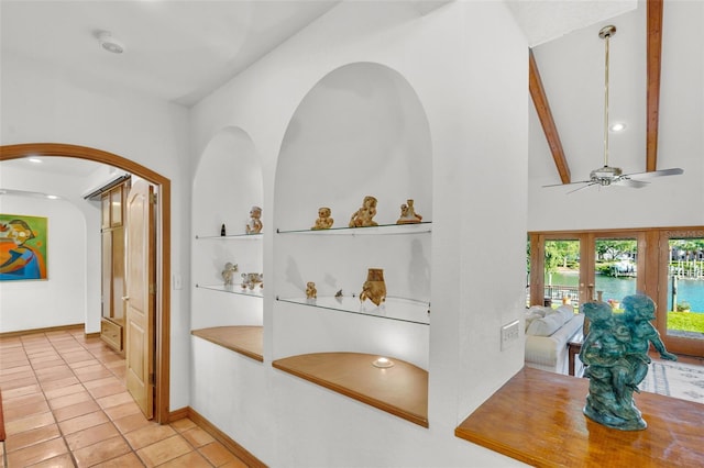 hall featuring high vaulted ceiling, light tile patterned floors, french doors, and beamed ceiling