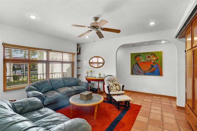 tiled living room with ceiling fan