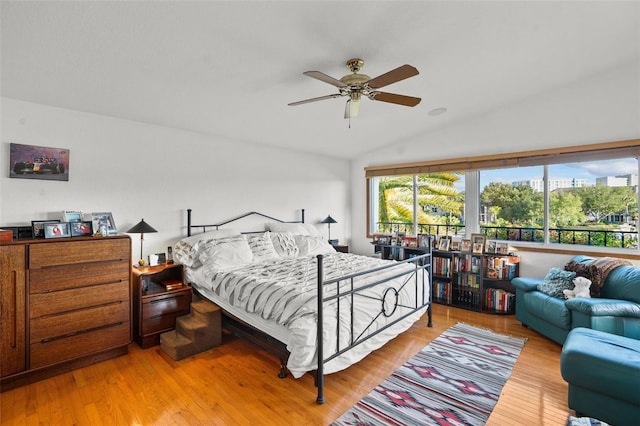 bedroom featuring light wood-type flooring, ceiling fan, and lofted ceiling