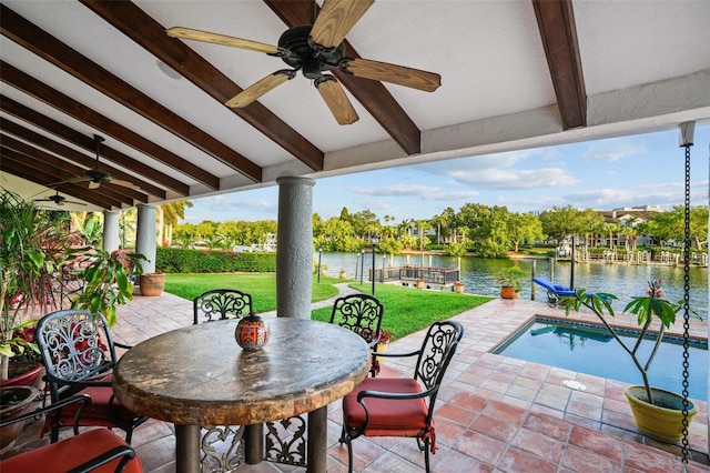 view of patio / terrace featuring ceiling fan and a water view