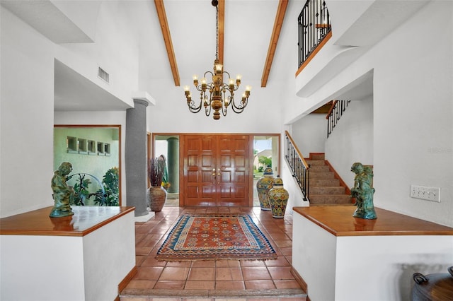 tiled entryway featuring high vaulted ceiling, a notable chandelier, and beamed ceiling