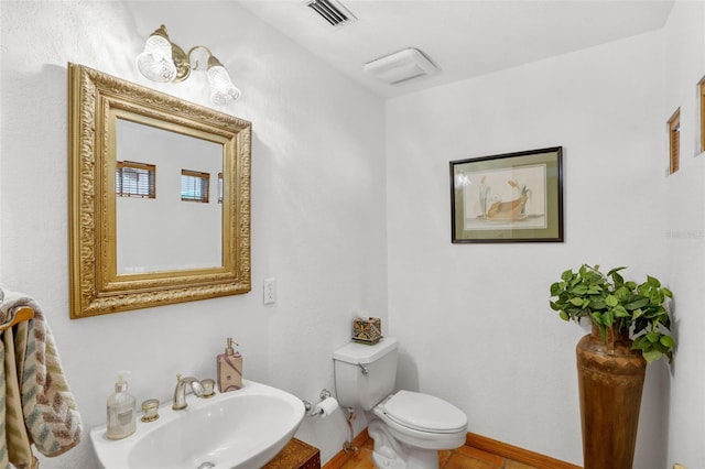 bathroom with toilet and sink