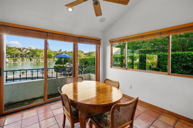 sunroom with a water view, vaulted ceiling, and ceiling fan