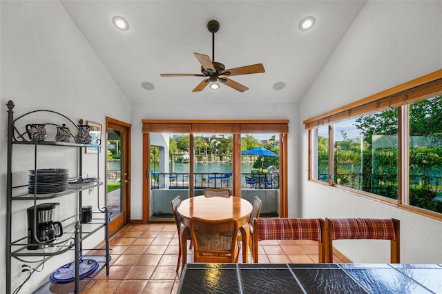 interior space with lofted ceiling, ceiling fan, and a water view