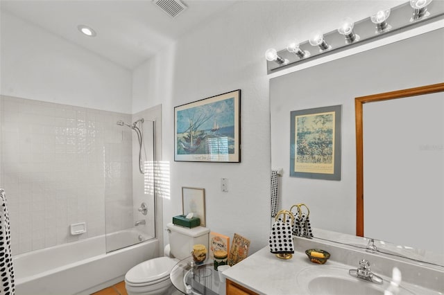 full bathroom featuring toilet, vanity, and tiled shower / bath