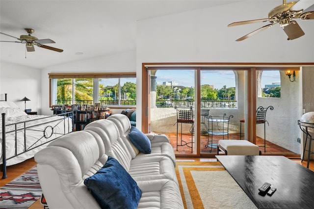 living room with ceiling fan, lofted ceiling, and hardwood / wood-style floors