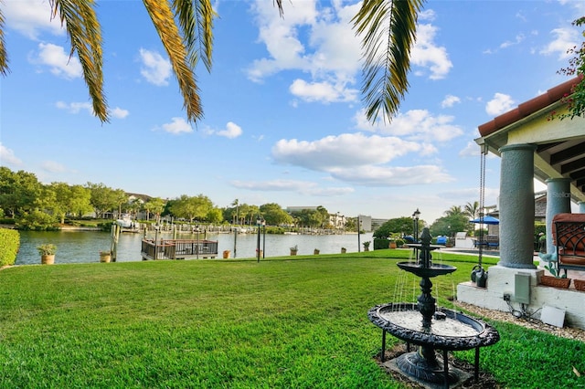 view of yard with a dock and a water view