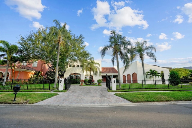 mediterranean / spanish home featuring a front lawn