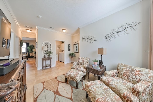 tiled living room featuring washer and dryer and crown molding