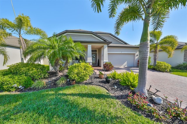 view of front of house with a front yard and a garage