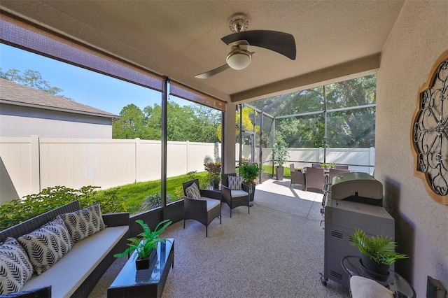 sunroom / solarium featuring ceiling fan