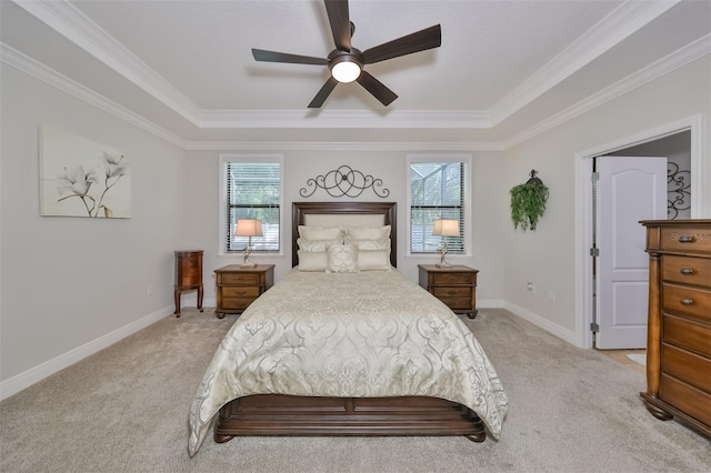 carpeted bedroom featuring a raised ceiling, ceiling fan, and ornamental molding