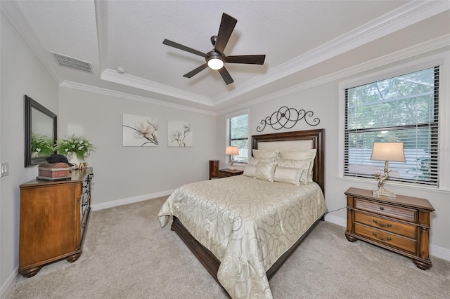 bedroom featuring ornamental molding, ceiling fan, carpet floors, and a tray ceiling