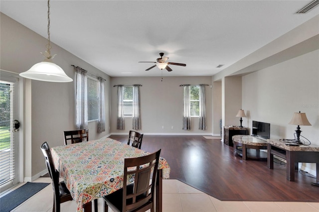 dining room with ceiling fan and light hardwood / wood-style floors