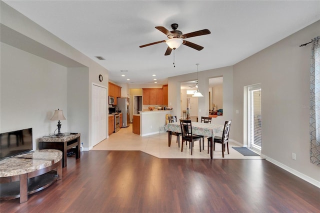 dining area featuring light wood-type flooring and ceiling fan