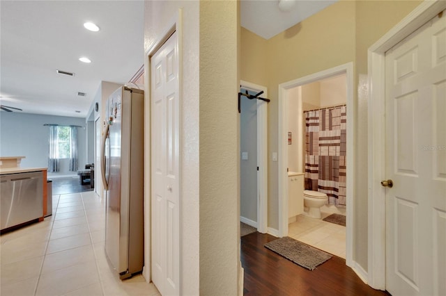 hallway with light hardwood / wood-style floors