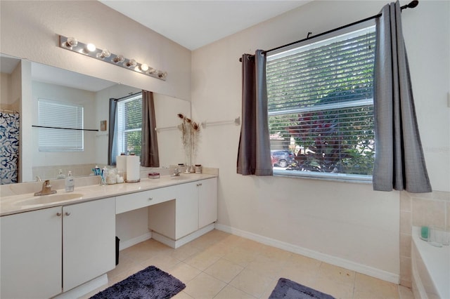 bathroom featuring a tub to relax in, vanity, and tile patterned flooring