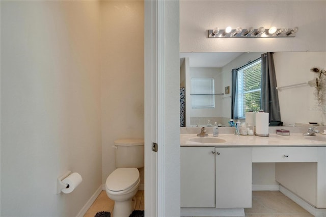 bathroom featuring vanity, toilet, and tile patterned floors