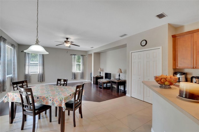 dining room with ceiling fan and light hardwood / wood-style floors