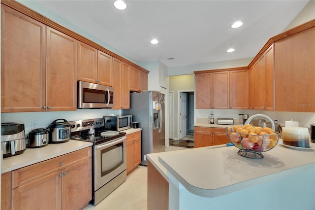 kitchen featuring light tile patterned floors and stainless steel appliances