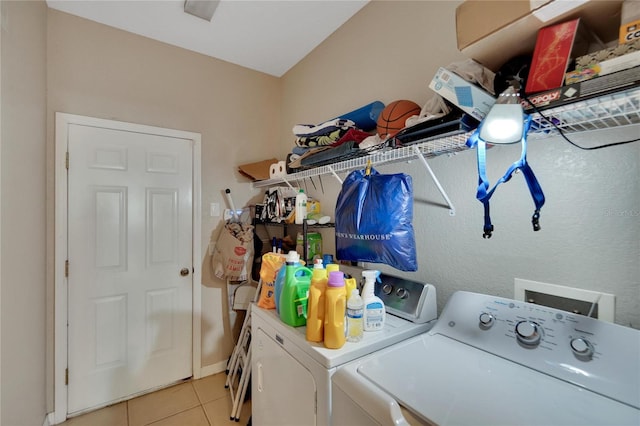 washroom with washer and clothes dryer and light tile patterned floors