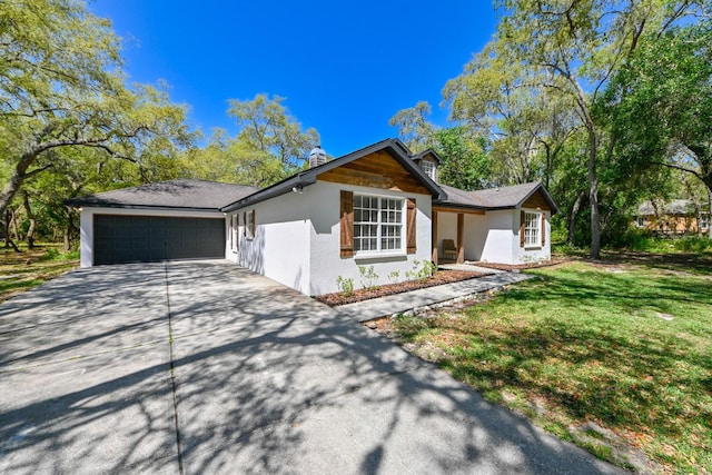 view of front of property featuring a garage and a front lawn