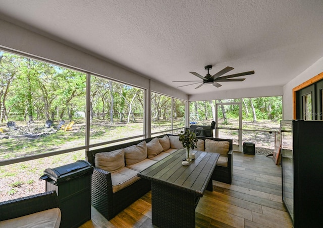 sunroom / solarium featuring ceiling fan and a wealth of natural light