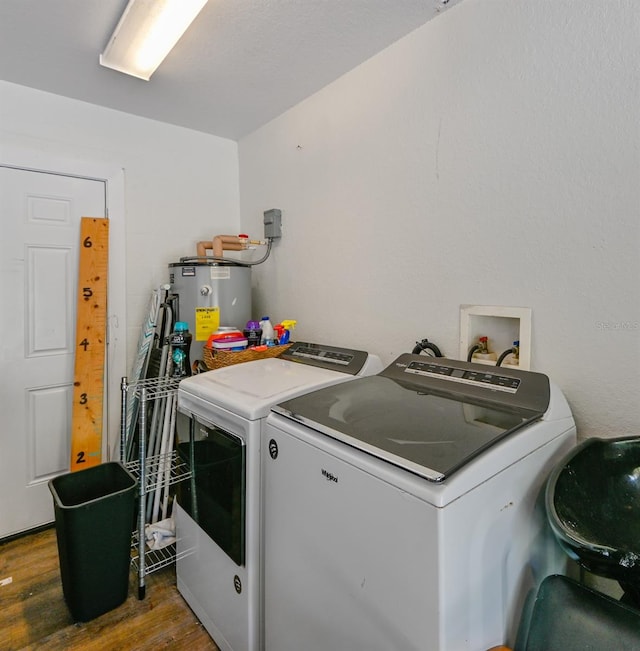 laundry area with dark hardwood / wood-style floors, water heater, and washing machine and dryer