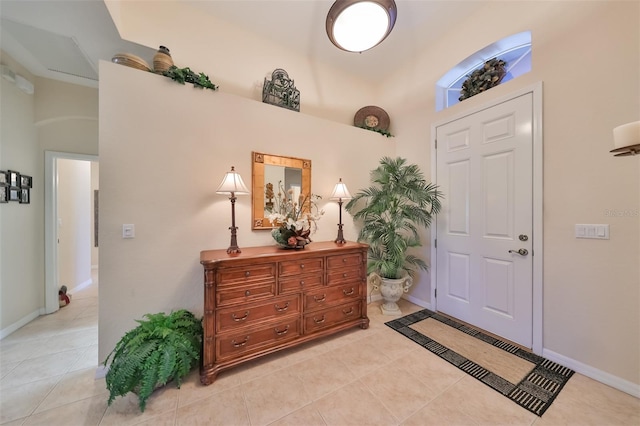 foyer entrance featuring a high ceiling and light tile floors