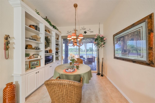 tiled dining room with built in features and an inviting chandelier