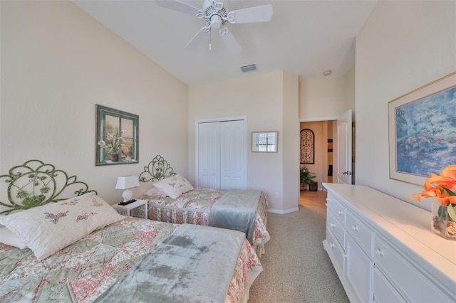 carpeted bedroom featuring a closet and ceiling fan